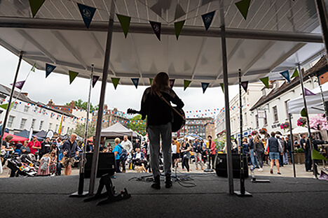 A performer on stage in front of a crowd